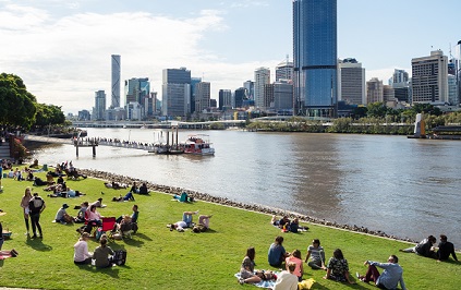 People sitting on riverbank in Brisbane